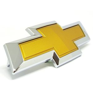 Emblema Dianteiro Dourado Gravata Da Grade Onix 1.0 tubo aspirado Peças Genuínas GM 26224695